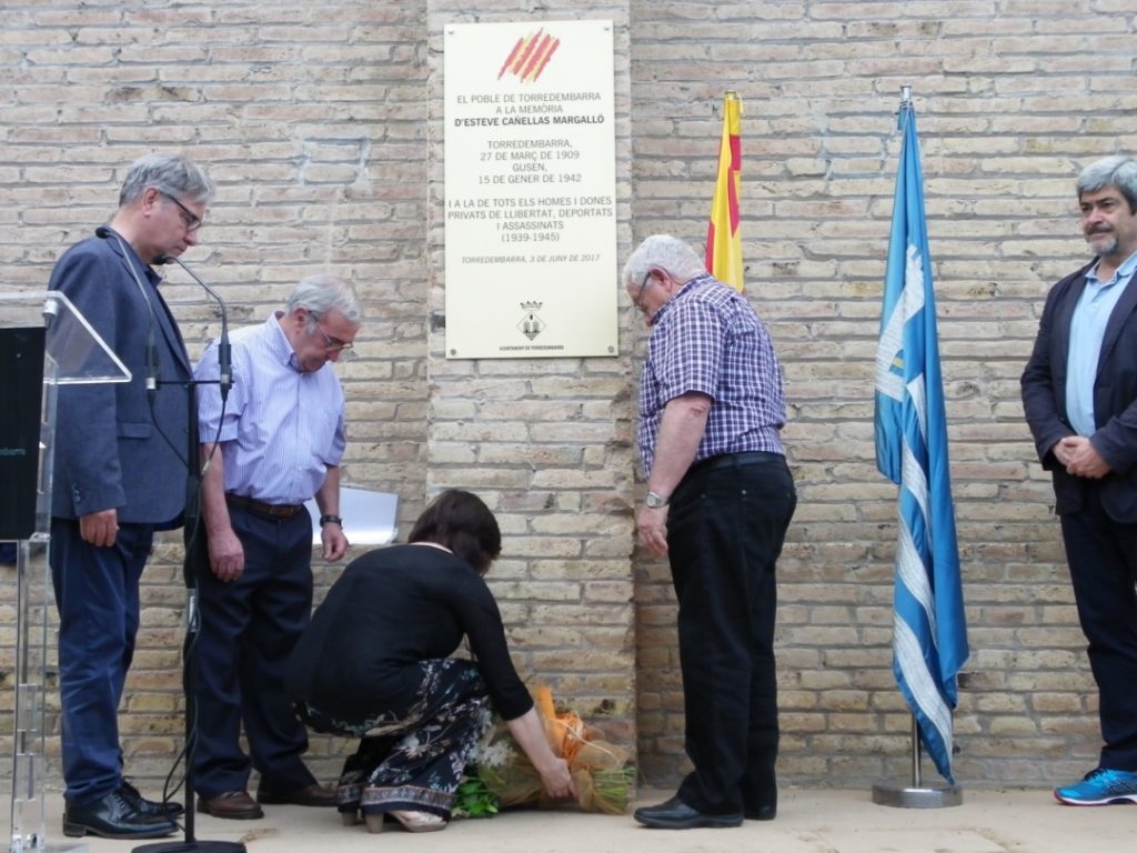 Familiars d'Esteve Cañellas posen unes flors sota la placa commemorativa. Foto: Romà Rofes / Tarragona21.cat